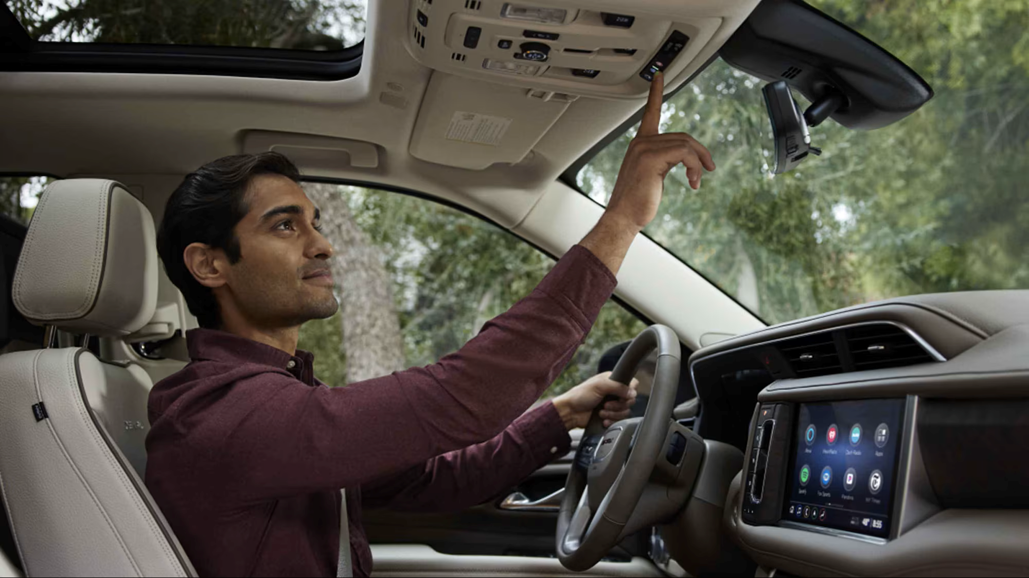 Man exploring OnStar features in a GMC vehicle