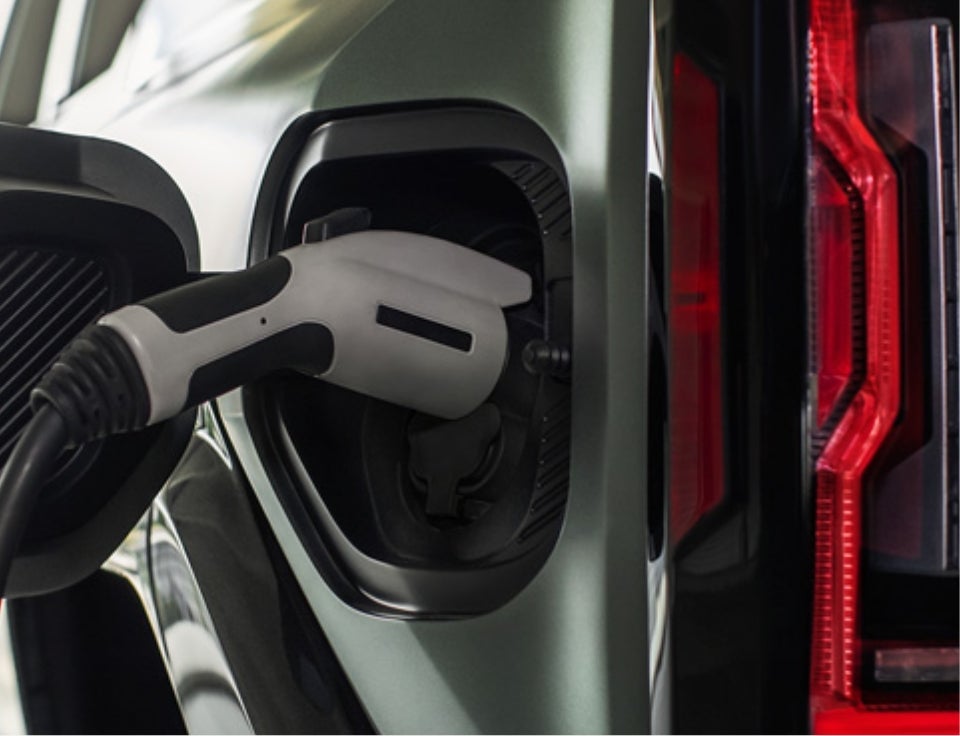 Close up of charging port with charger plugged in on a GMC Hummer EV SUV - Blaise Alexander GMC of Hazelton in Hazleton PA